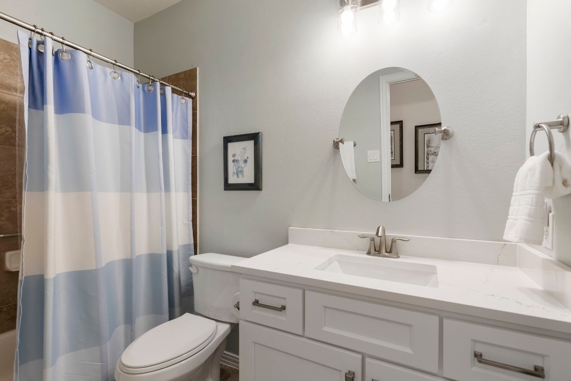 3214 Clover Trace Drive Spring, TX 77386 - Photo 30 of 48 a bathroom with a sink a toilet and shower curtain