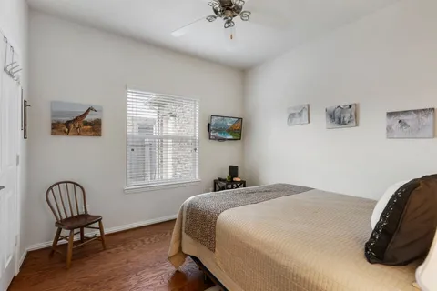 a bedroom with a bed chair and a window