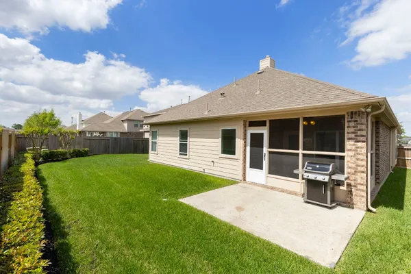 a front view of a house with a garden and yard