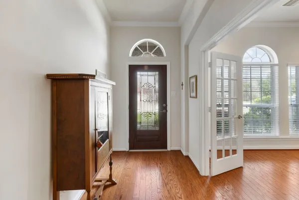 a view of an entryway with wooden floor and door