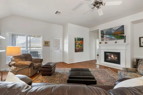 a living room with furniture and a fireplace