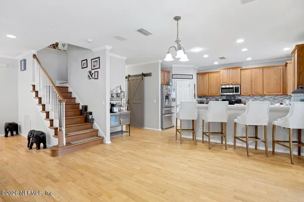 a view of kitchen with furniture and refrigerator