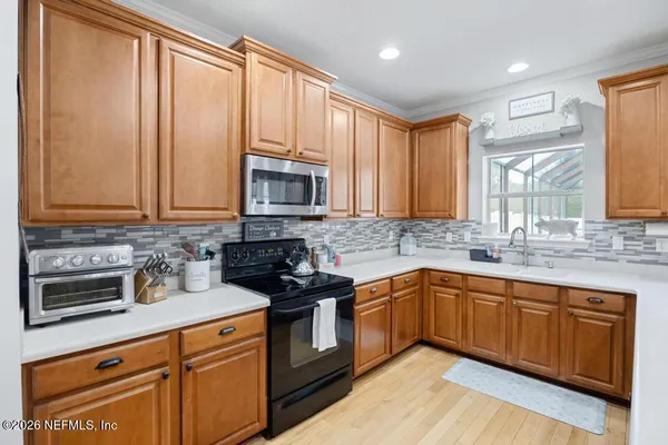 a kitchen with stainless steel appliances granite countertop a sink stove and microwave