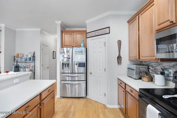 a kitchen with white cabinets and stainless steel appliances