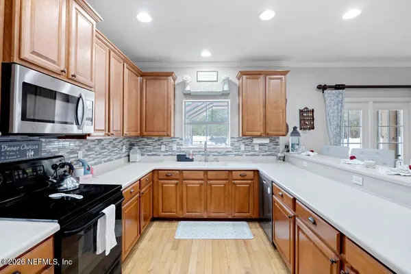 a kitchen with stainless steel appliances granite countertop a sink stove and cabinets