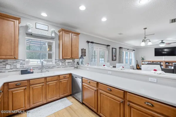 a kitchen with sink a microwave and cabinets
