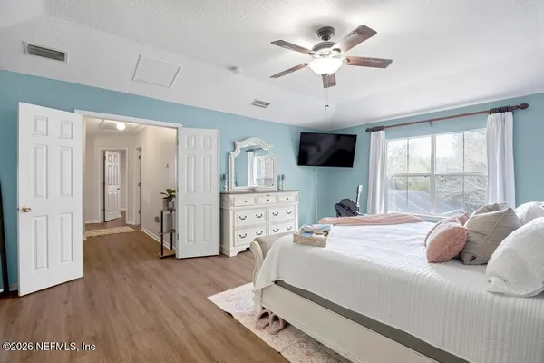 a bed room with a bed and a large window