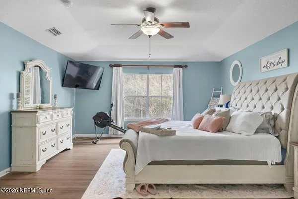 a bedroom with a large bed and a window