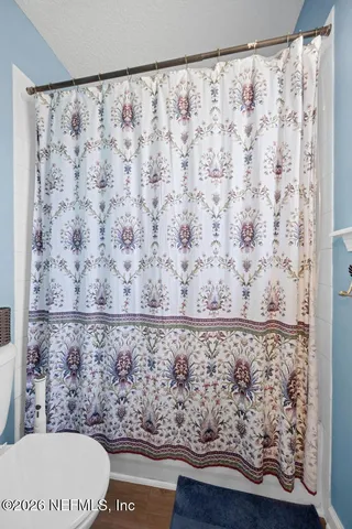 a bathroom with a bathtub and shower