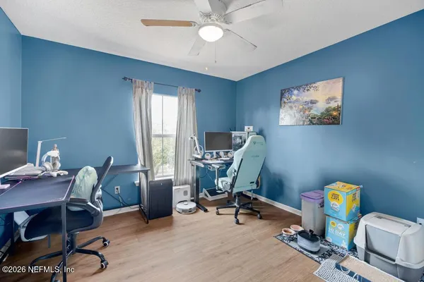 a view of a workspace with furniture and a window