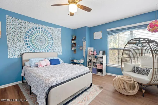 a bedroom with a bed couch and a window