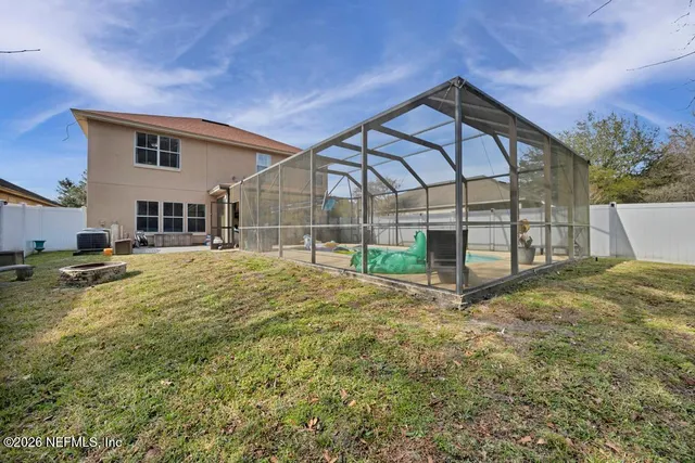 an aerial view of a house with a swimming pool