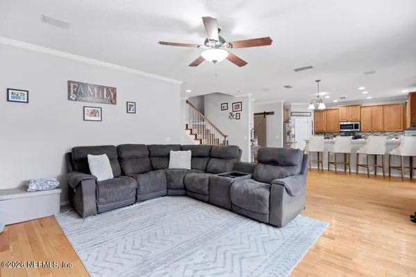 a living room with furniture and kitchen view