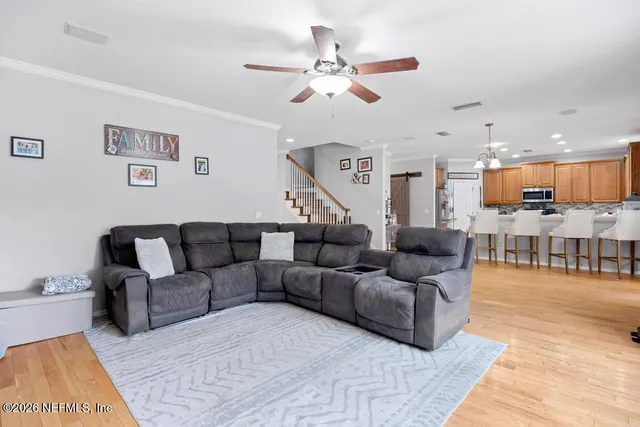 a living room with furniture and kitchen view