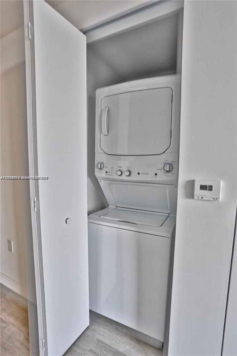 55 Southwest 9th Street, Unit 1910 Miami, FL 33130 - Photo 9 of 11 a utility room with dryer and washer