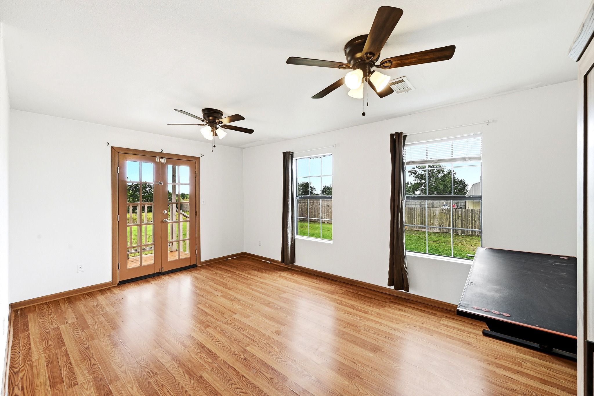 320 Sunset Ridge Maxwell, TX 78656 - Photo 22 of 32 a view of an empty room with a window and wooden floor