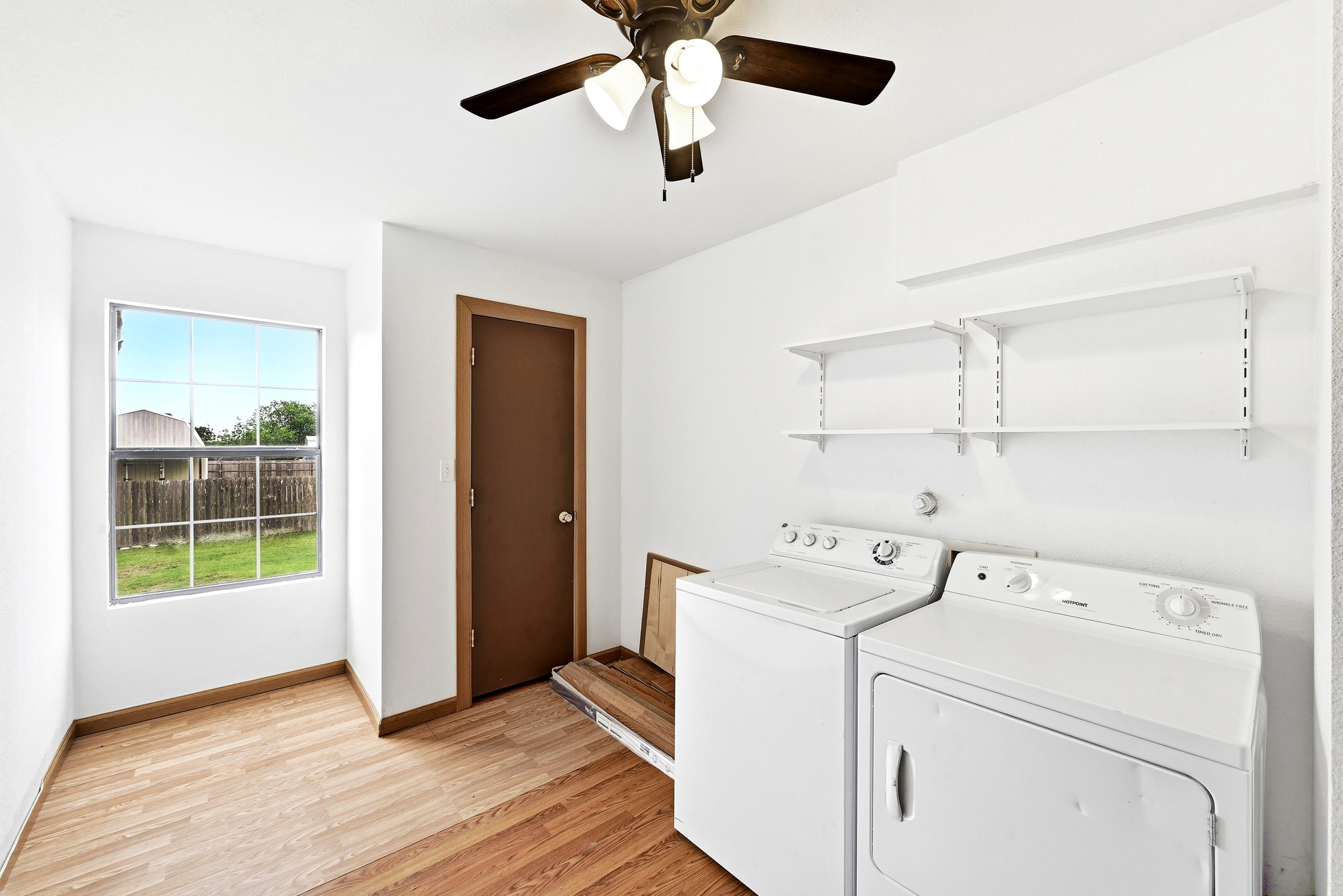 320 Sunset Ridge Maxwell, TX 78656 - Photo 24 of 32 a view of washer and dryer with kitchen in the background
