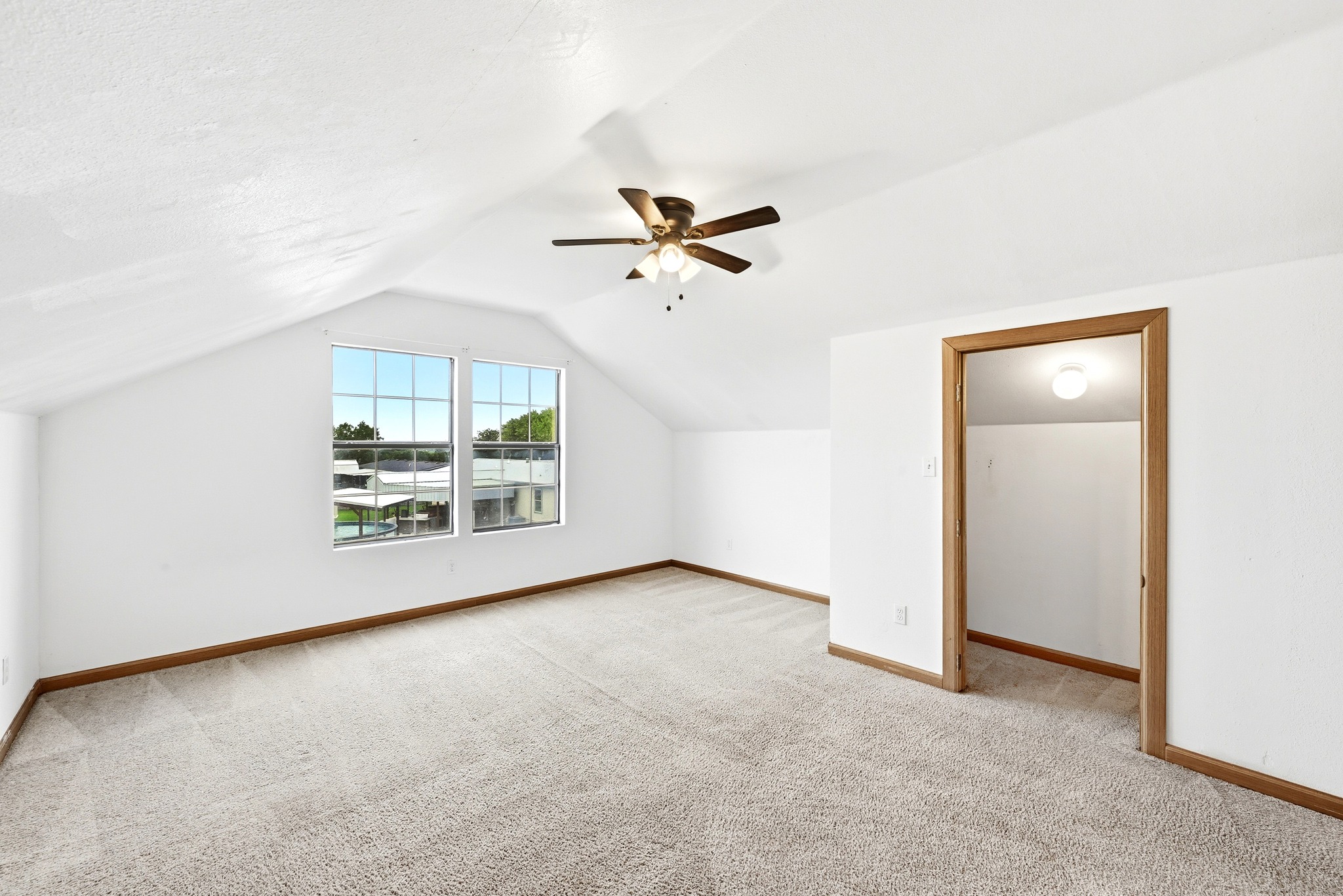 320 Sunset Ridge Maxwell, TX 78656 - Photo 25 of 32 an empty room with chandelier fan and windows