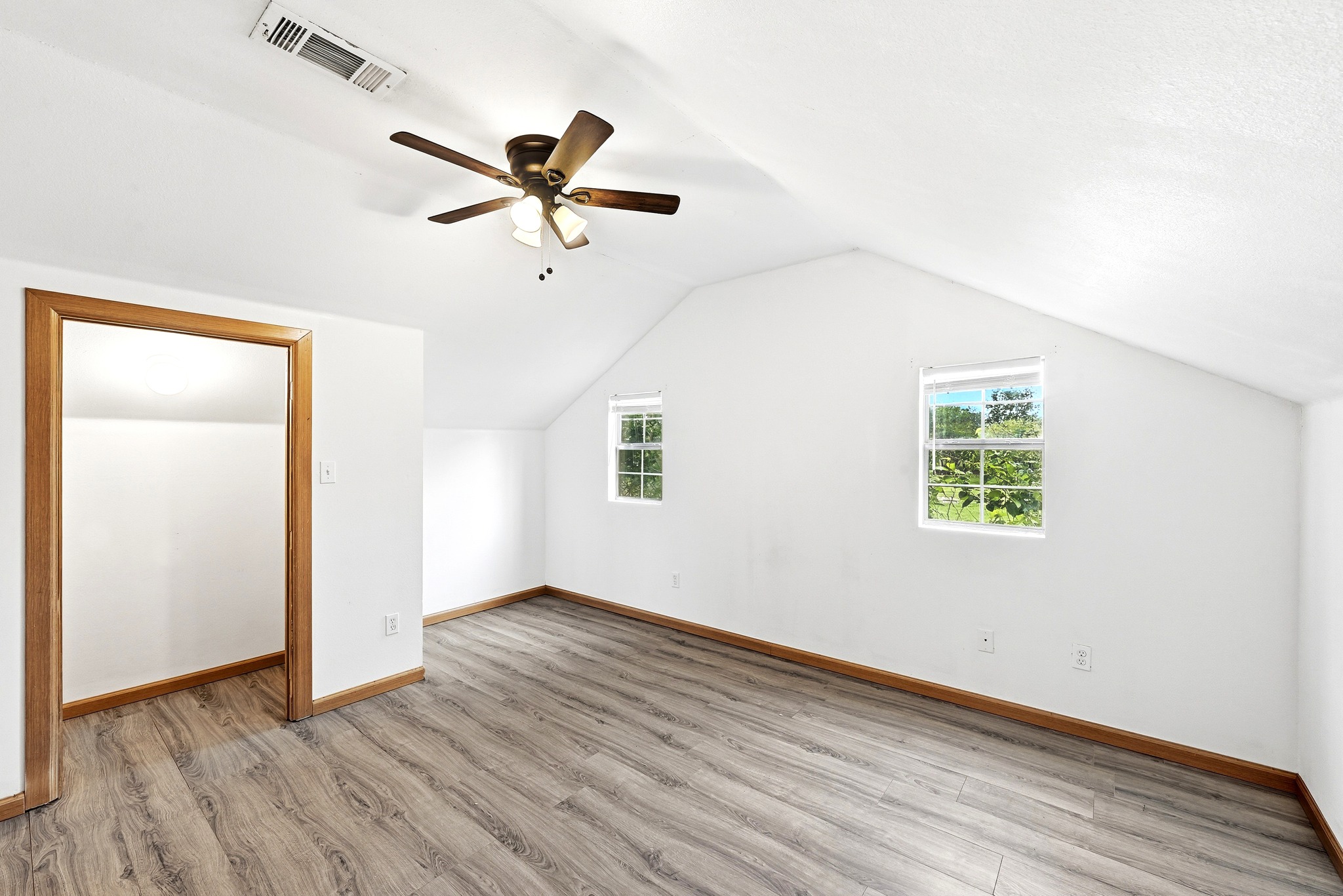 320 Sunset Ridge Maxwell, TX 78656 - Photo 26 of 32 an empty room with wooden floor fan and windows
