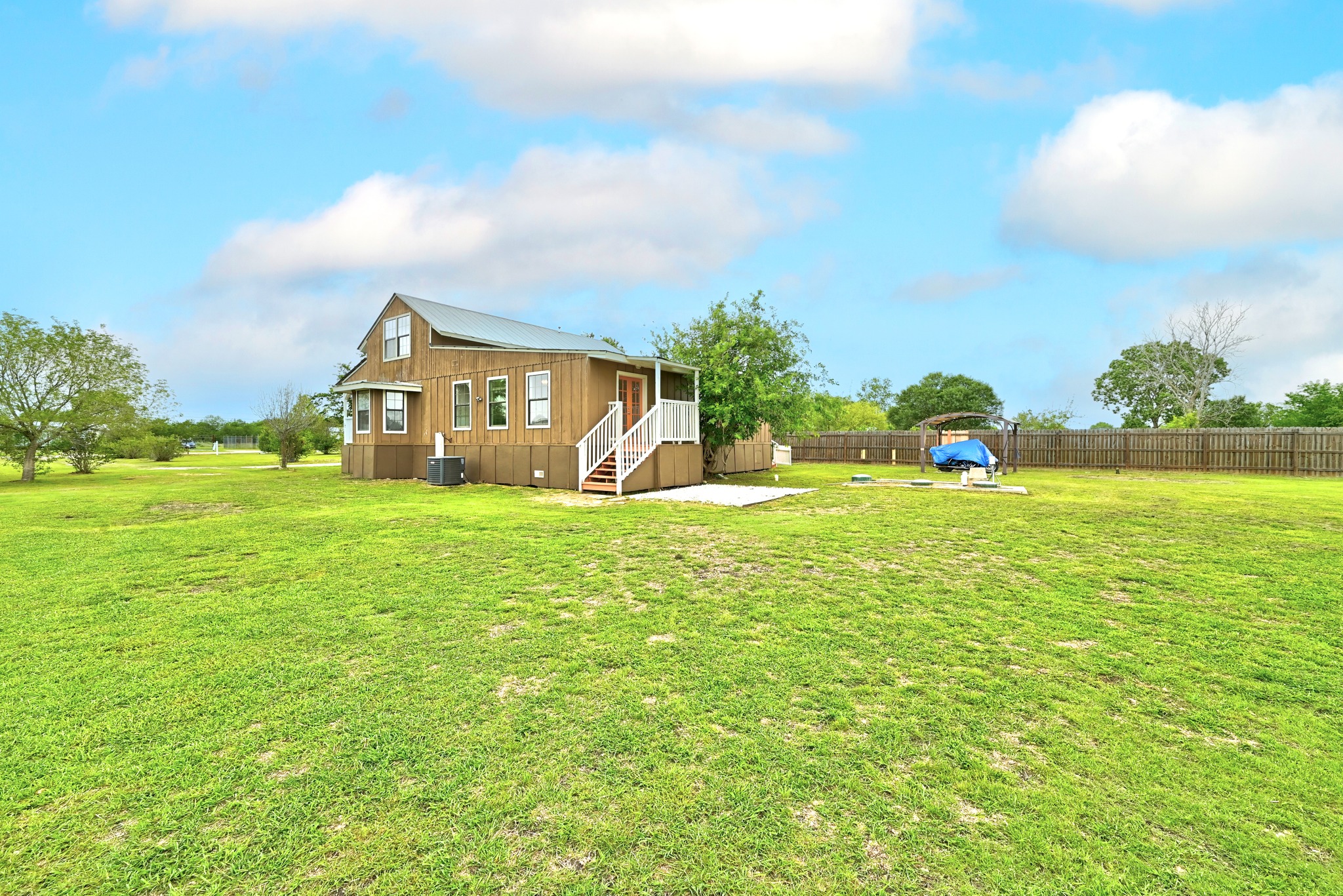 320 Sunset Ridge Maxwell, TX 78656 - Photo 29 of 32 a view of a house with a big yard and potted plants