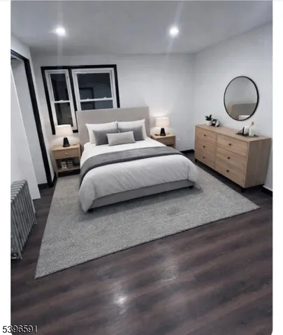 a bedroom with bed and a large window