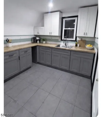 a kitchen with a sink cabinets and window