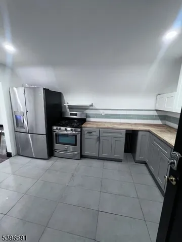 a kitchen with a cabinets and steel stainless steel appliances