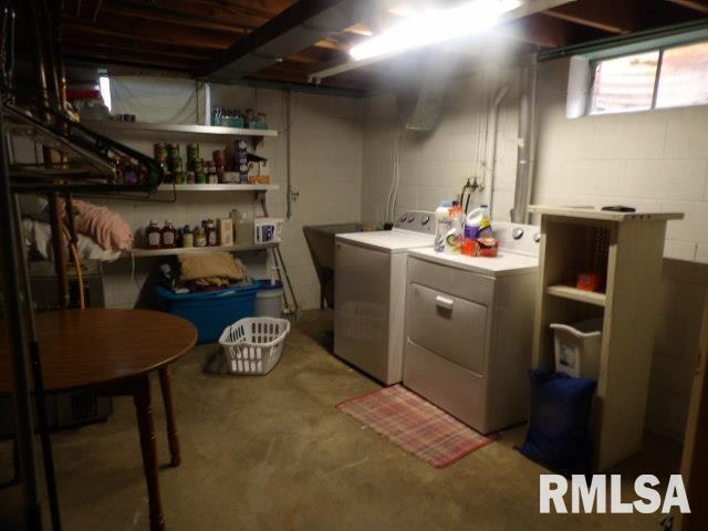 736 North Mill Street Carrier Mills, IL 62917 - Photo 28 of 35 a room with stainless steel appliances kitchen island granite countertop a table chairs and a refrigerator
