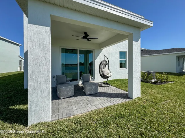 a view of a porch with a table and chairs
