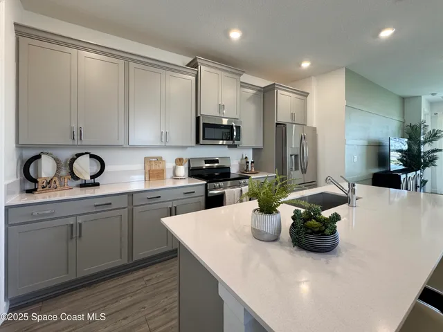 a kitchen with a sink appliances and cabinets