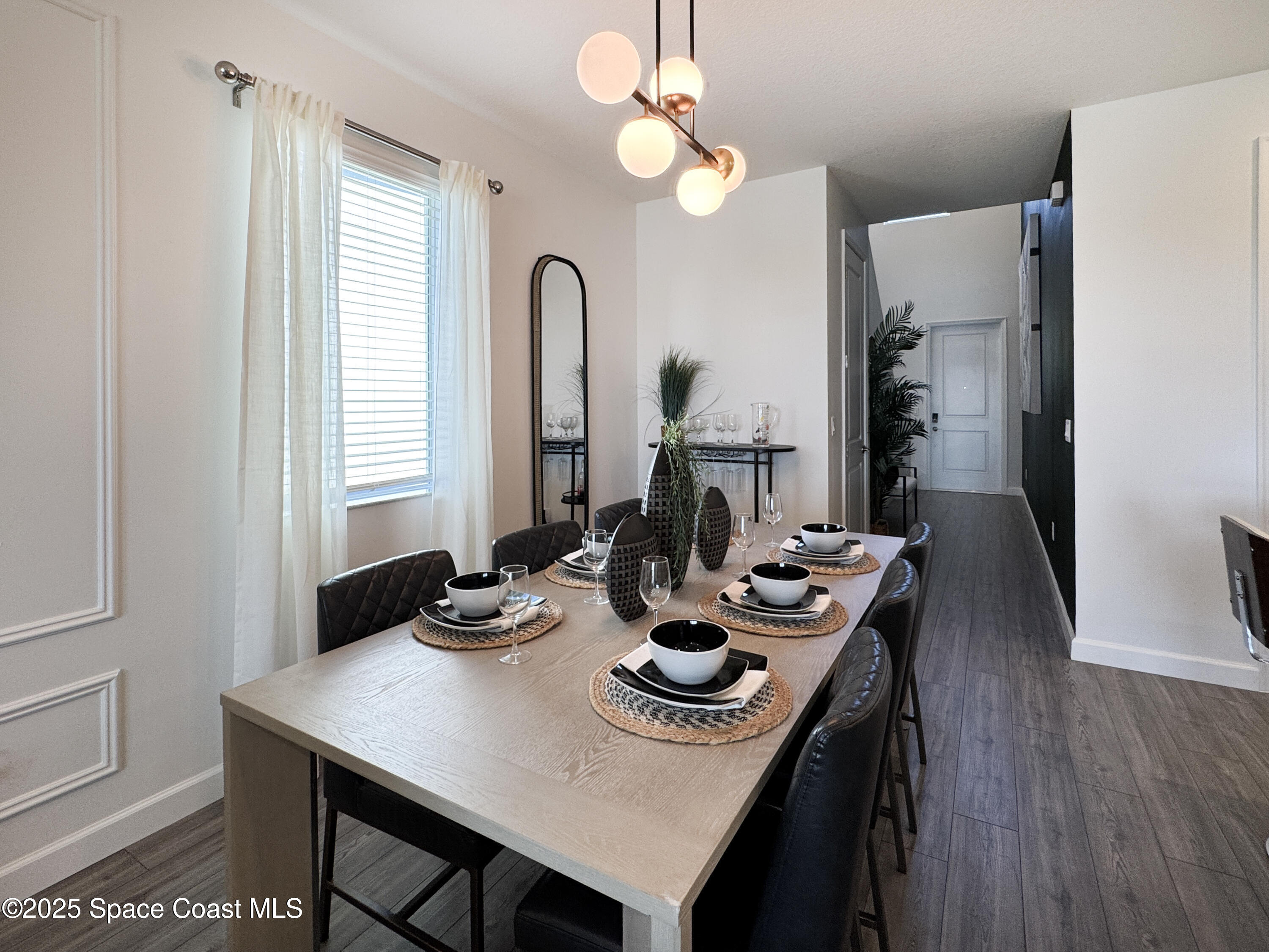 1959 Croft Inlet Drive Palm Bay, FL 32907 - Photo 7 of 23 a view of a dining room with furniture and wooden floor