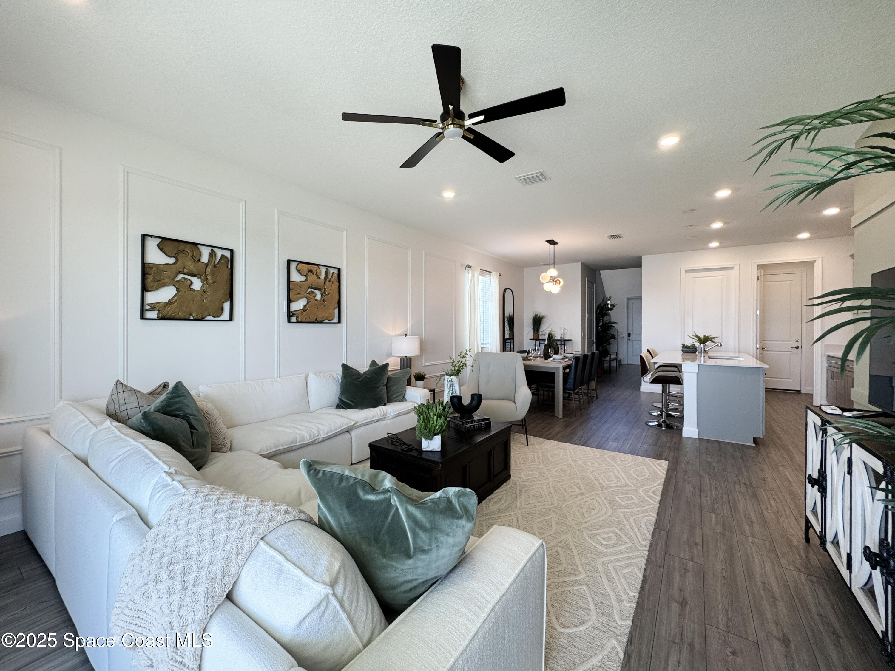 1959 Croft Inlet Drive Palm Bay, FL 32907 - Photo 9 of 23 a living room with furniture kitchen view and a wooden floor