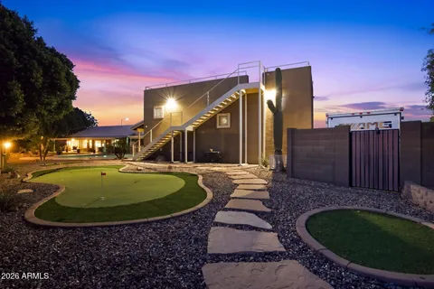 a view of a backyard with plants and patio