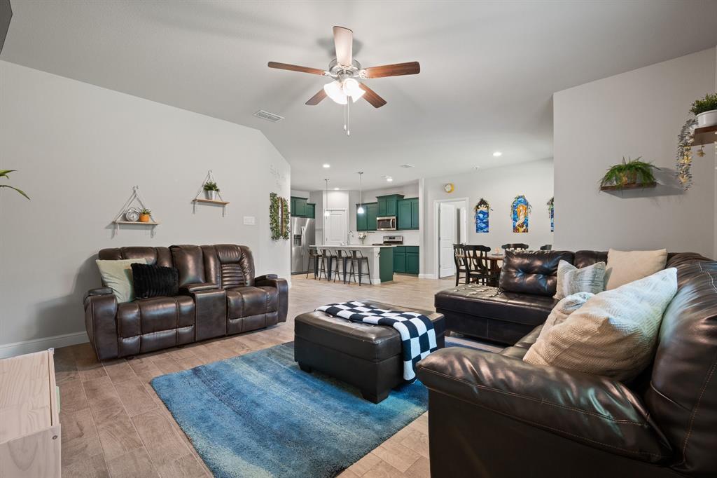 5709 Round Hl Road Denton, TX 76210 - Photo 11 of 31 a living room with furniture ceiling fan and a rug