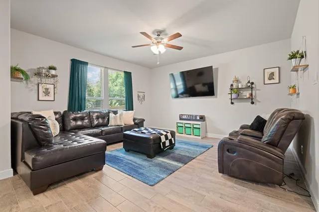 a living room with fireplace furniture and a flat screen tv