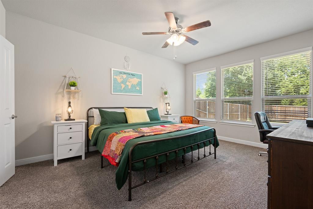 5709 Round Hl Road Denton, TX 76210 - Photo 15 of 31 a bedroom with a bed and a chandelier