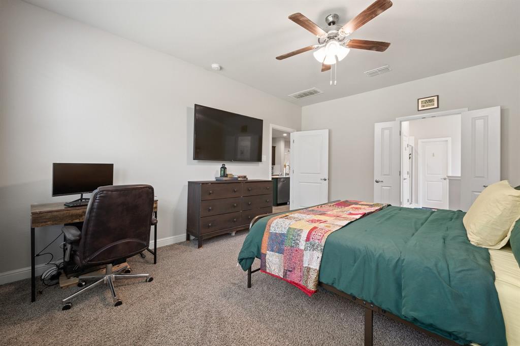 5709 Round Hl Road Denton, TX 76210 - Photo 17 of 31 a bedroom with a bed and a flat screen tv