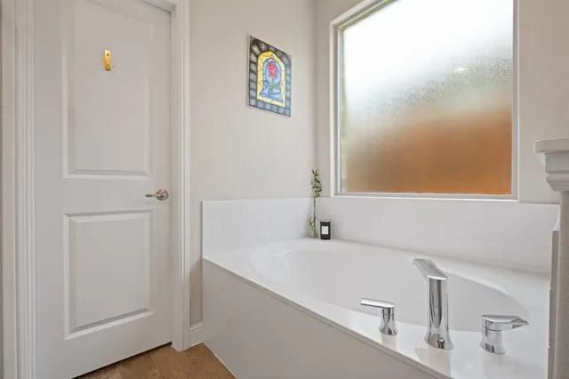 a bathroom with a tub and a sink