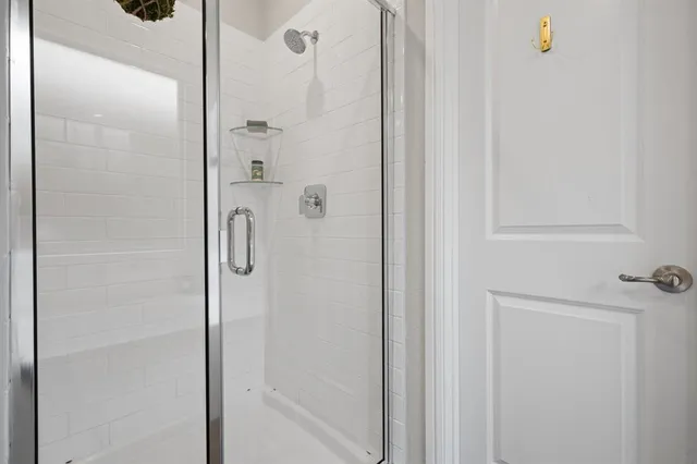 a bathroom with a glass shower door