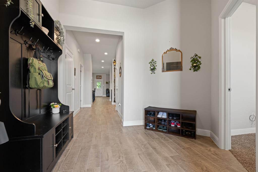 5709 Round Hl Road Denton, TX 76210 - Photo 3 of 31 a view of a hallway with wooden floor and a living room