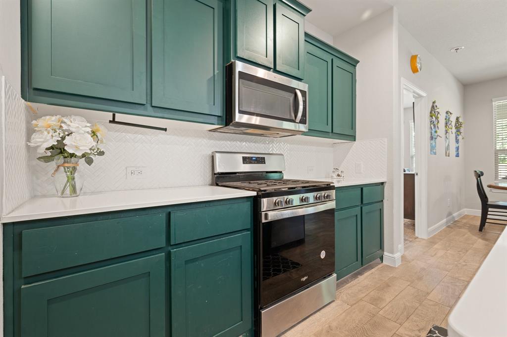 5709 Round Hl Road Denton, TX 76210 - Photo 6 of 31 a kitchen with granite countertop cabinets stainless steel appliances and wooden floor