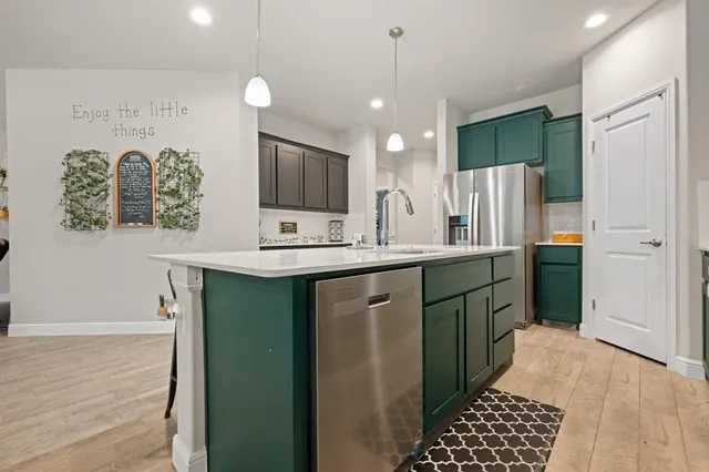 a kitchen with a refrigerator and a sink