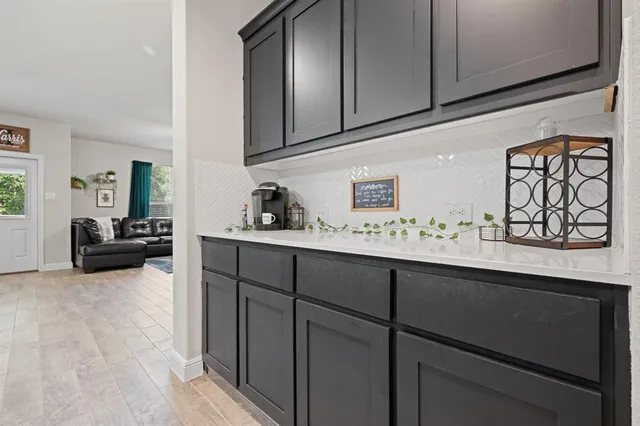 a kitchen with sink and cabinets