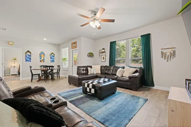 a living room with furniture and wooden floor