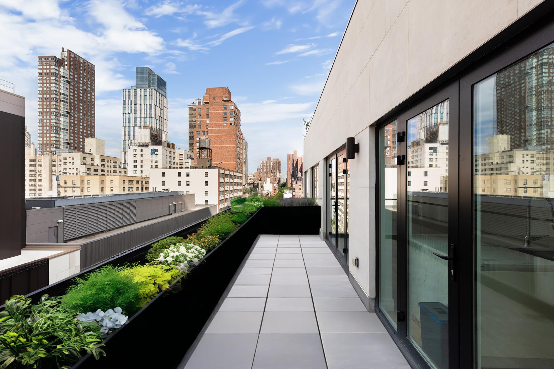 427 East 90th Street, Unit PH10 Manhattan, NY 10128 - Photo 24 of 28 a view of a city from a balcony