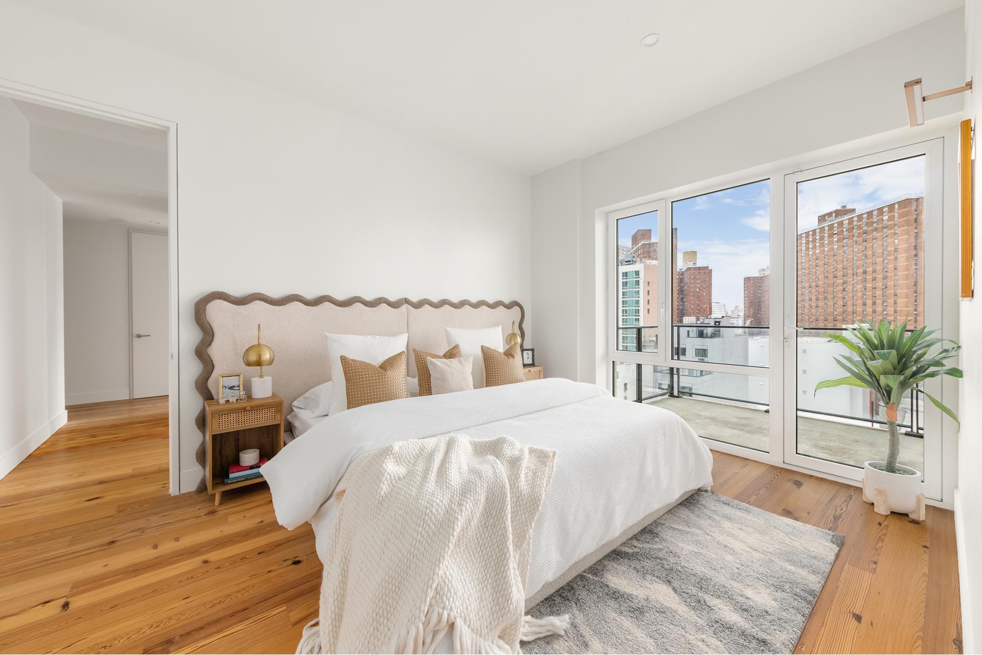 427 East 90th Street, Unit PH10 Manhattan, NY 10128 - Photo 27 of 28 a bedroom with a bed and wooden floor