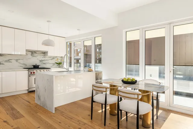 a kitchen with a table chairs stove and cabinets