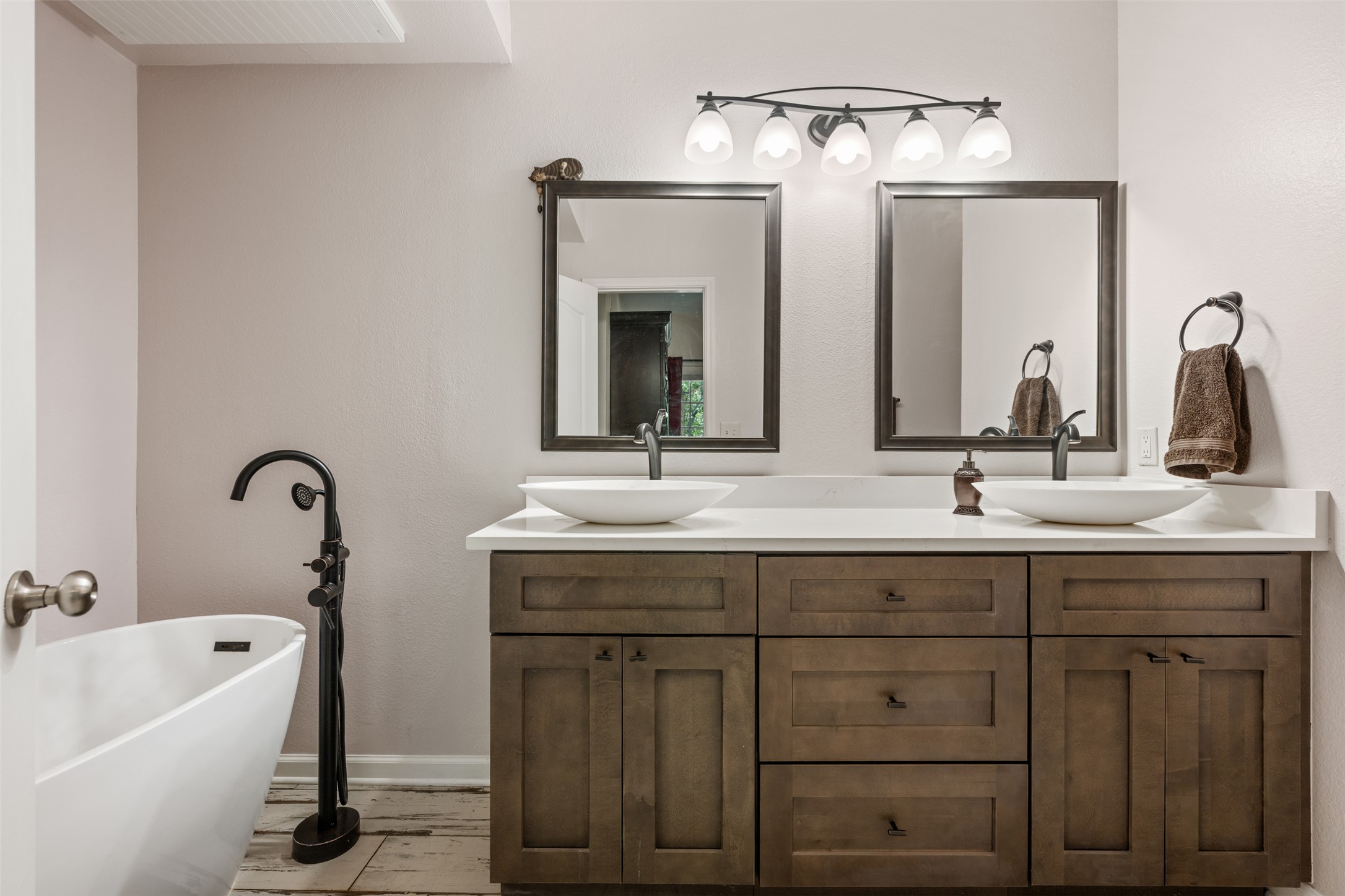 11203 Ranch Road 2222, Unit 1407 Austin, TX 78732 - Photo 3 of 40 The primary ensuite bath is updated with refined modern finishes including a contemporary dual vanity.