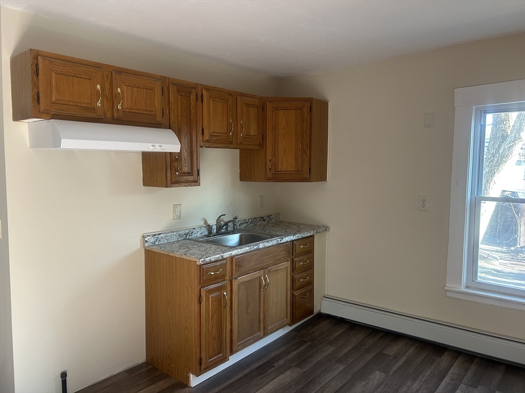 19 Pine Street Athol, MA 01331 - Photo 12 of 25 a kitchen with a stove a microwave a sink and cabinets