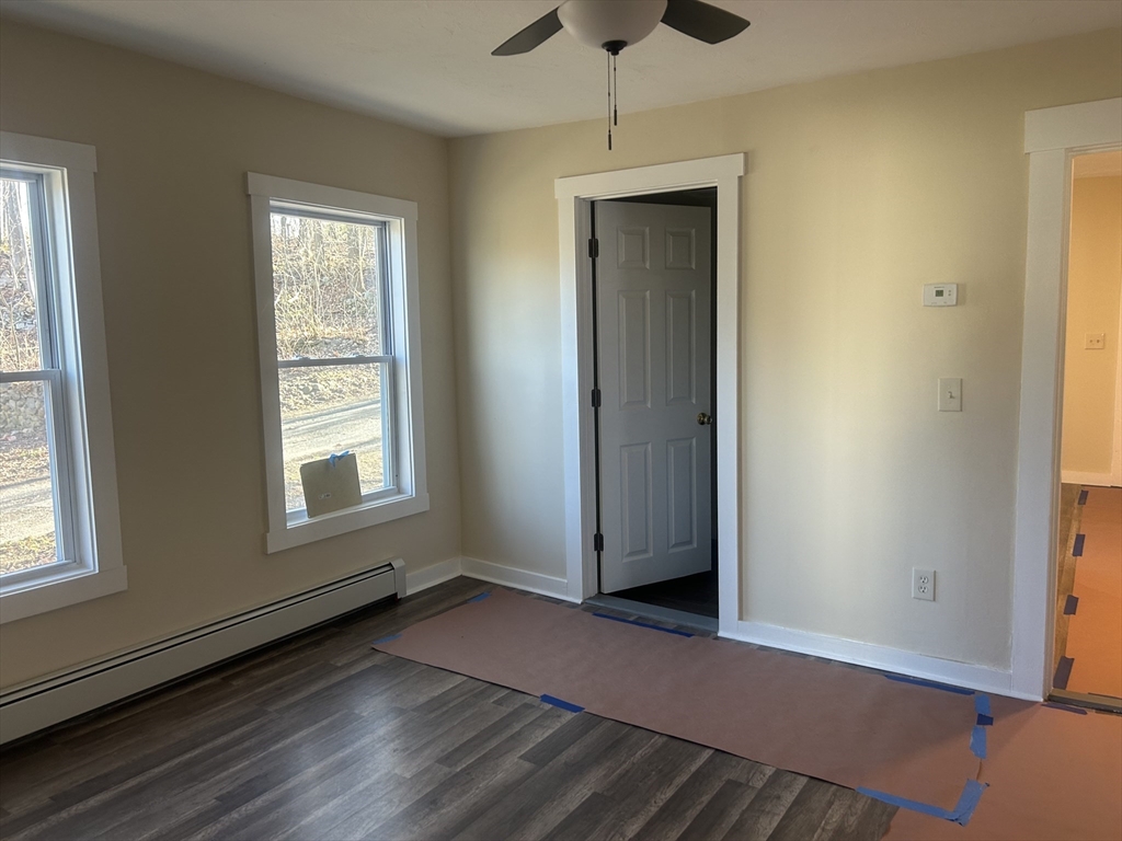19 Pine Street Athol, MA 01331 - Photo 16 of 25 an empty room with wooden floor closet and windows